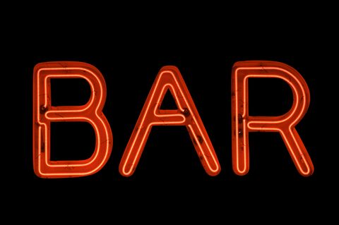 bar sign in red neon on black