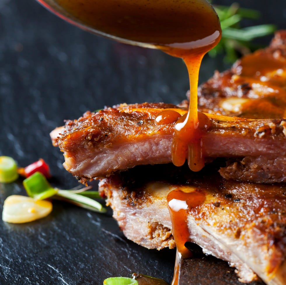 Barbecue sauce dripping on marinated and grilled spare ribs Barbecue sauce dripping on marinated and grilled spare ribs