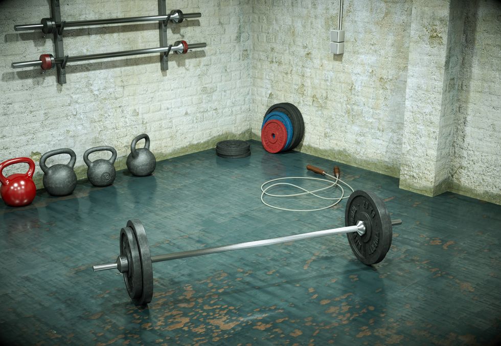 Barbell with black plates on a gym floor