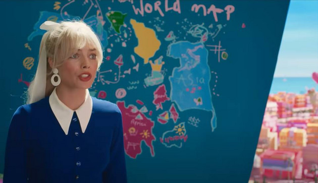margot robbie as barbie standing in front of a doodled and inaccurate world map in the barbie film