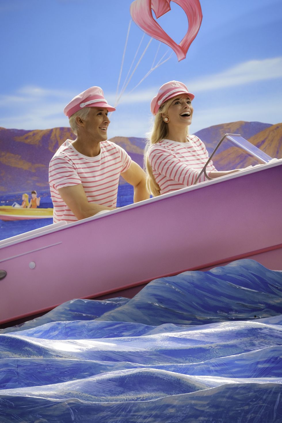 barbie and ken in a pink boat from the barbie movie