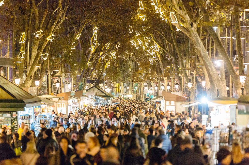 People walking at La Rambla street during Christmas and New Year holidays in Barcelona, Catalonia, Spain