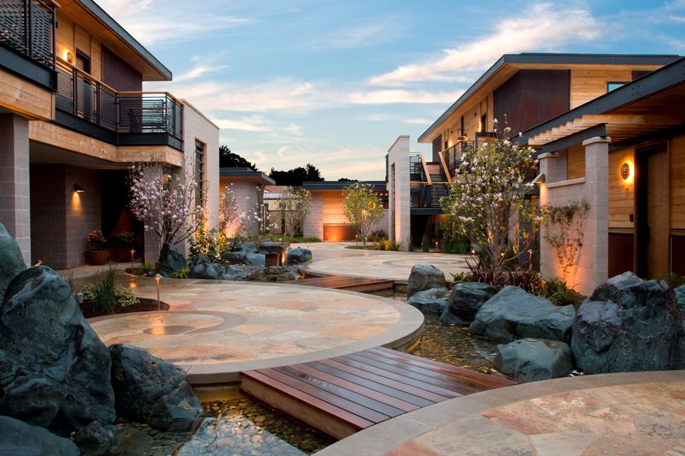 a courtyard with a fountain and rocks