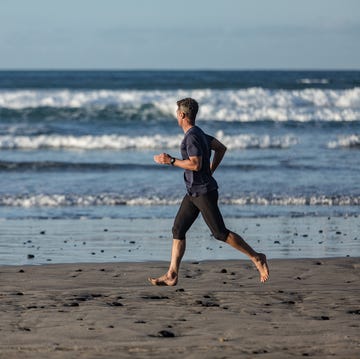 barefoot man in sports clothes running on the beach barefoot man in sports clothes running on the beach