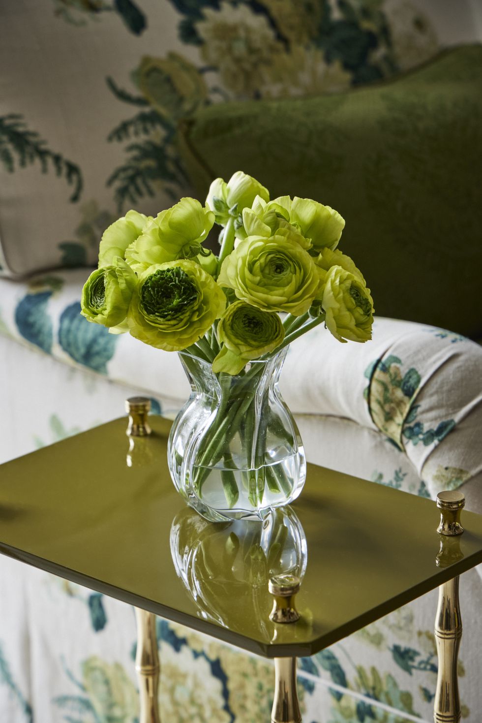 green flowers in a glass vase