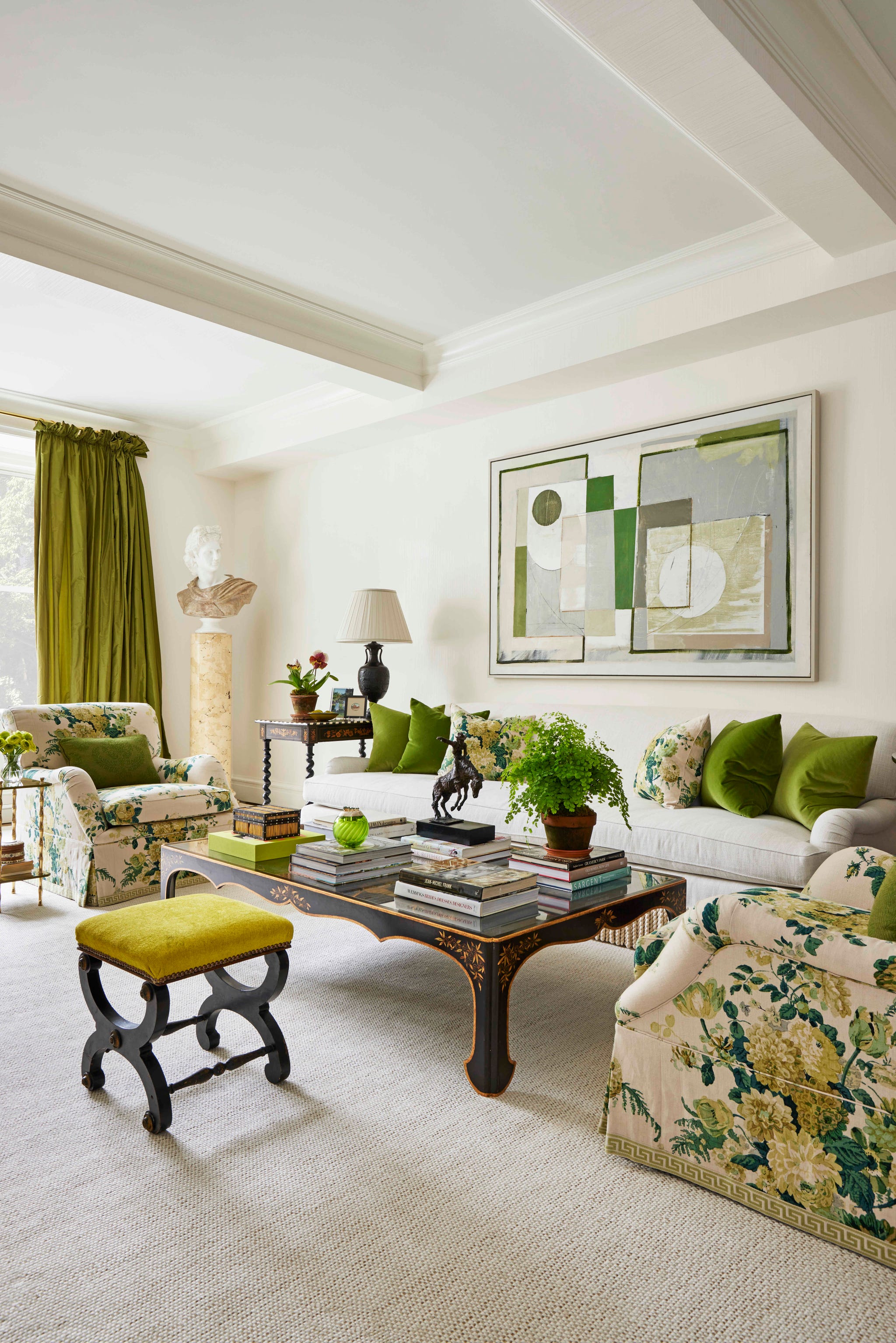 an oil painting by london artist daisy cook hangs over a nine foot sofa upholstered in stain resistant fabric and the coffee table is crafted from a 19th century chinese screen