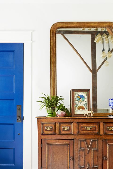 bright blue door in an all white entryway