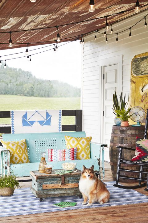 turquoise vintage glider on a colorful rustic back porch