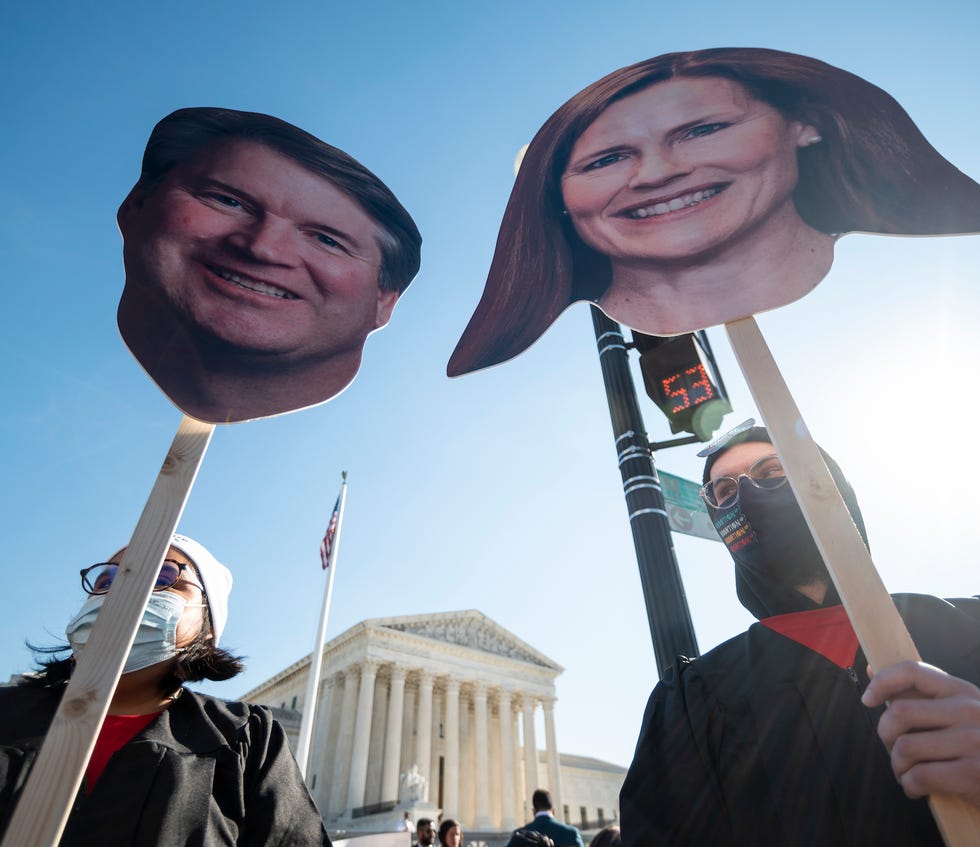 united states   december 1 reproductive rights activists hold cut out photos of justices brett kavanaugh and amy coney barrett as oral arguments in dobbs v jackson womens health organization case are held on wednesday, december 1, 2021 the case considers the constitutionality of mississippis restrictive ban on abortion after 15 weeks  photo by bill clarkcq roll call, inc via getty images