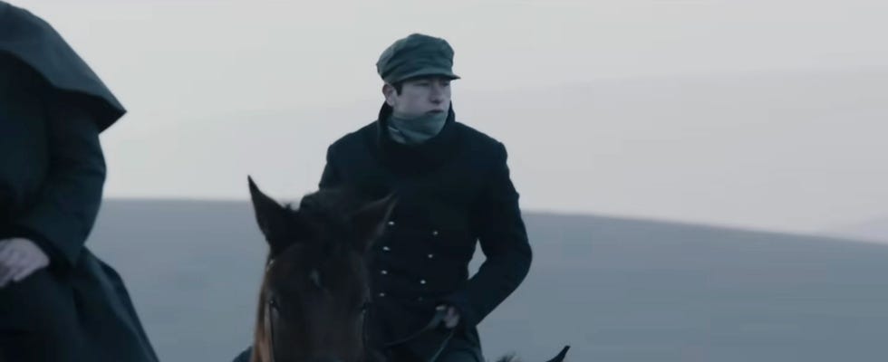 Barry Keoghan on horseback wearing a dark coat and cap in the black trailer 47