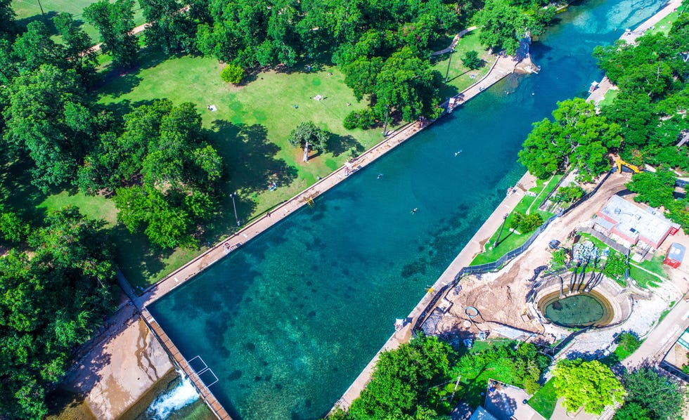 Barton Springs Natural Swimming Pool is one of the Best in the World aerial drone view of Summer Swimming hole in Austin , Texas elle escapes austin