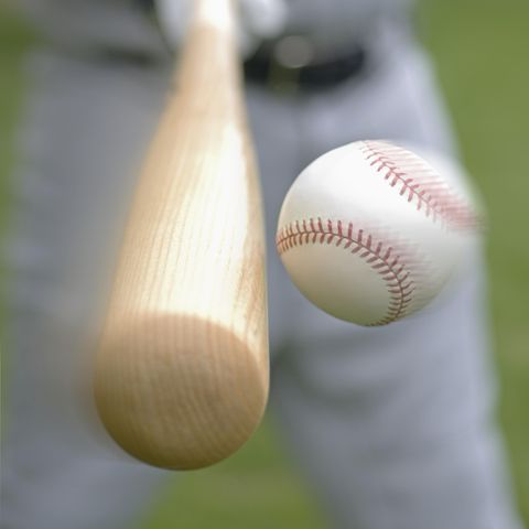 closeup of baseball player hitting ball