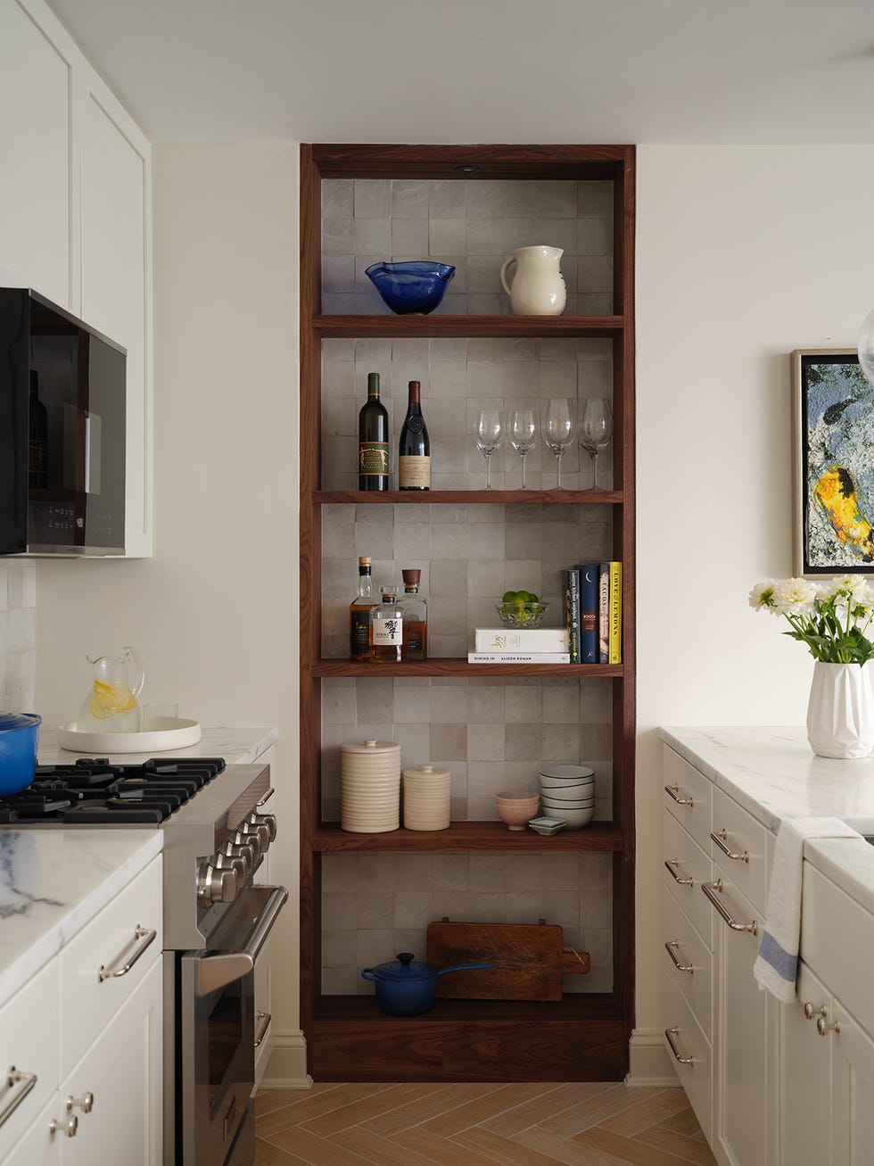 basement kitchen with bookshelf and white cabinets