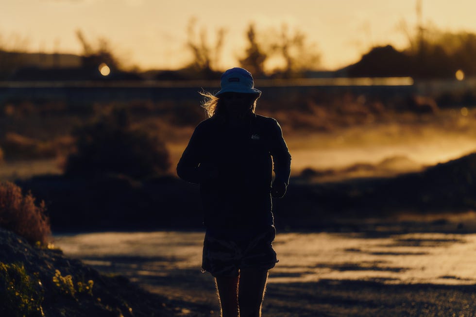 a person jogging outdoors at sunset