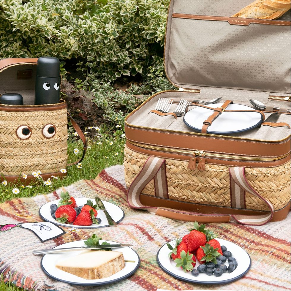 a table with plates of food and a basket with a basket and a chair