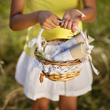 basket with gift packages held in a girl's hands