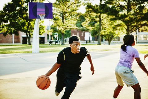 Basketball player driving toward basket