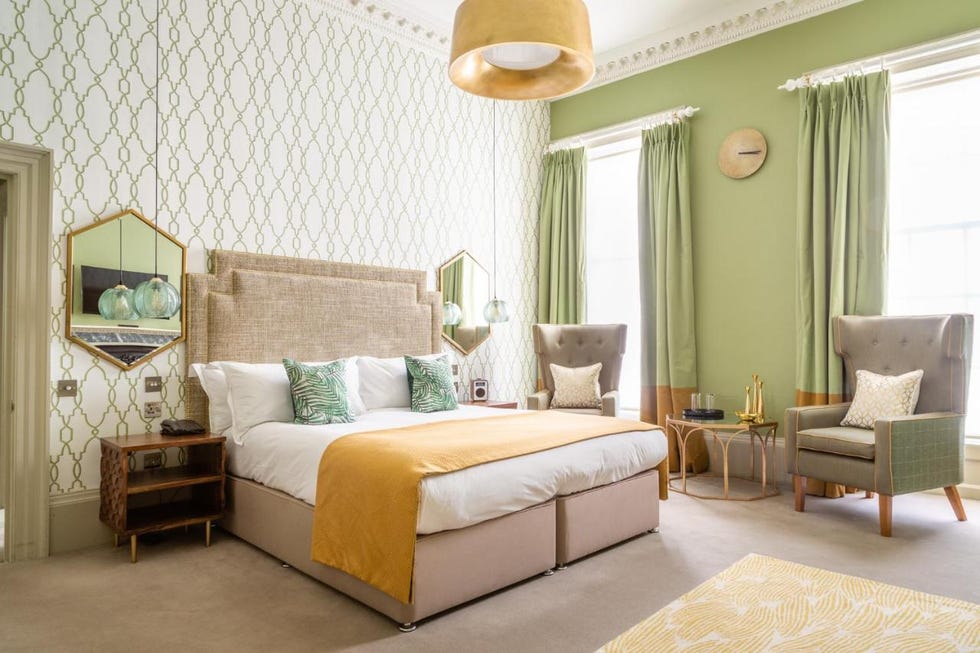 a bedroom with a bed and a chair