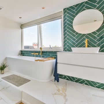 bathroom design mistakes the interior of a bathroom decorated with marble and gold colored equipment in a modern house