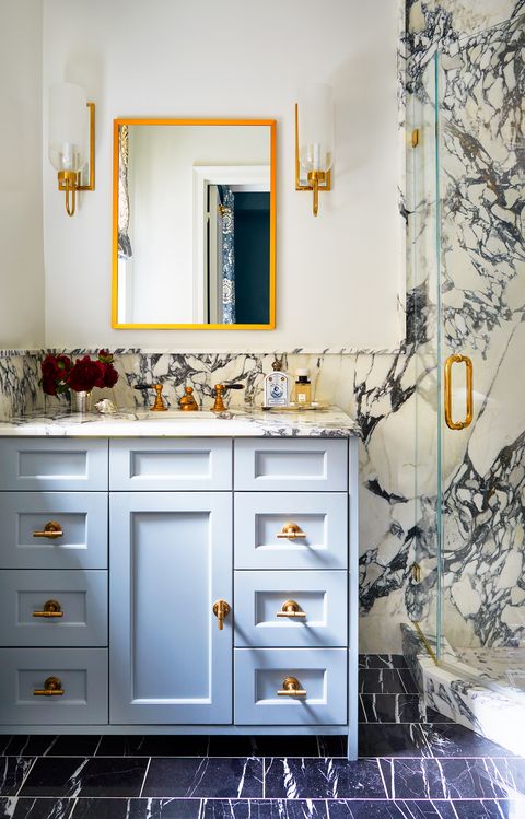 bathroom with blue vanity and marble