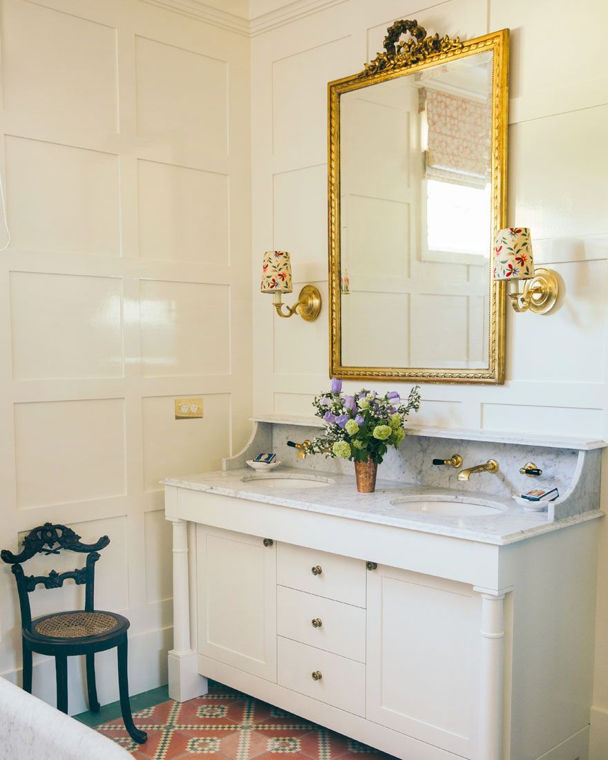 traditional formal bathroom with lampshade sconces