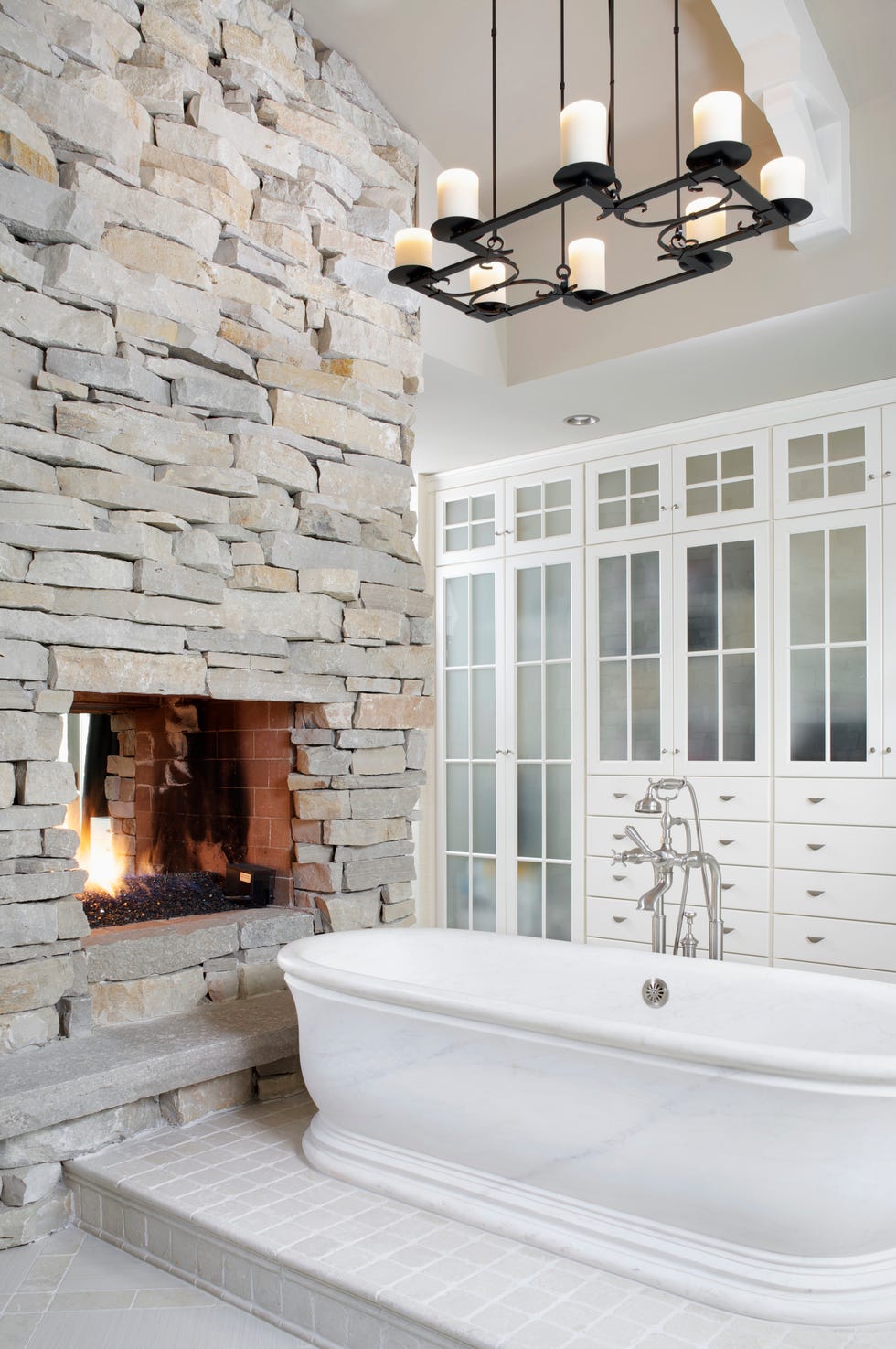 bathroom lighting ideas, master bath with fireplace and bathtub