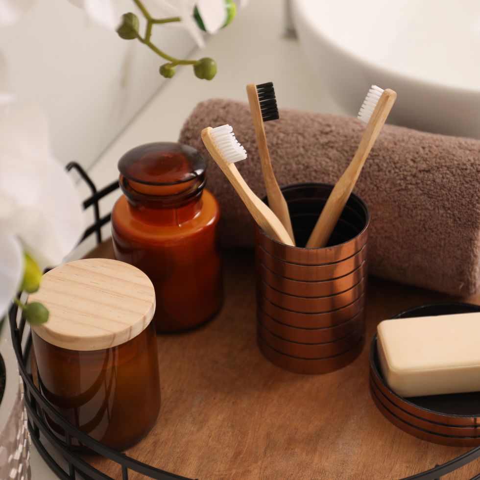 bathroom organization ideas, brown decorative tray holding a toothbrush, bar of soap and other toiletries