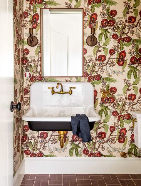 bathroom with colorful wallpaper and schoolhouse sink