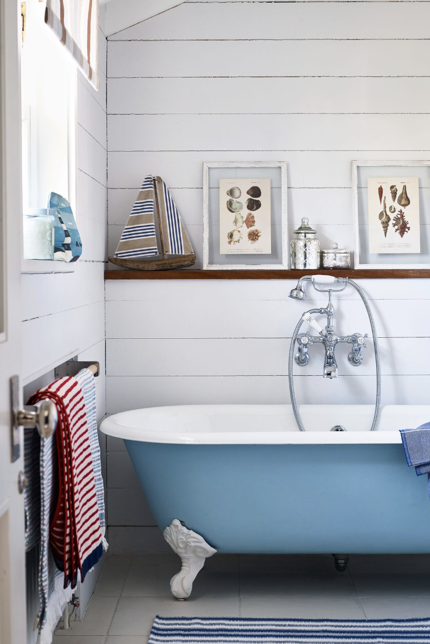bathroom shelf ideas, a wood ledge beside the tub with pictures