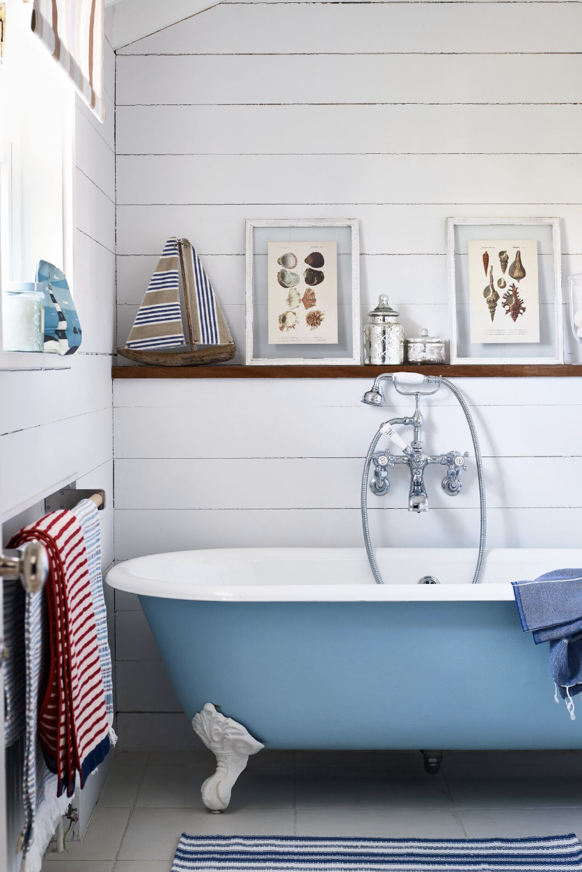 bathroom shelf ideas, a wood ledge beside the tub with pictures