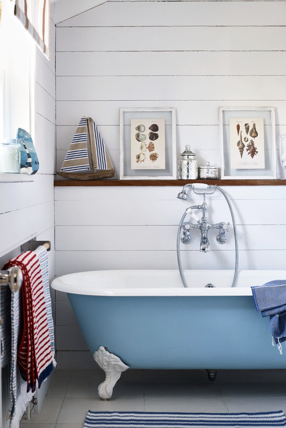 bathroom storage ideas, wooden ledge over the blue tub with a white rim