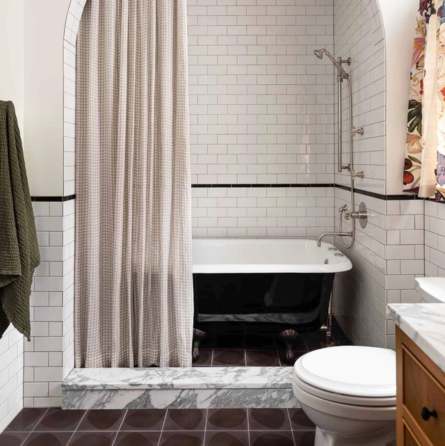 bathroom with clawfoot tub and tiles