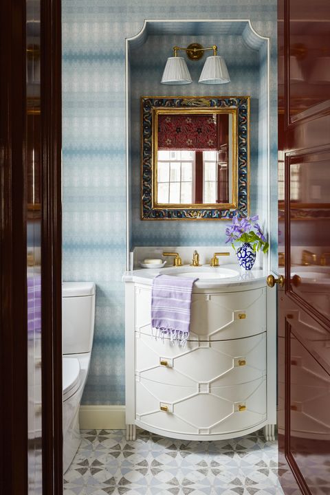 a custom curved vanity with moldings and a merlot lacquered door arroyo red, benjamin moore reflect the movement of the blue wallpaper in this katie ridder powder room