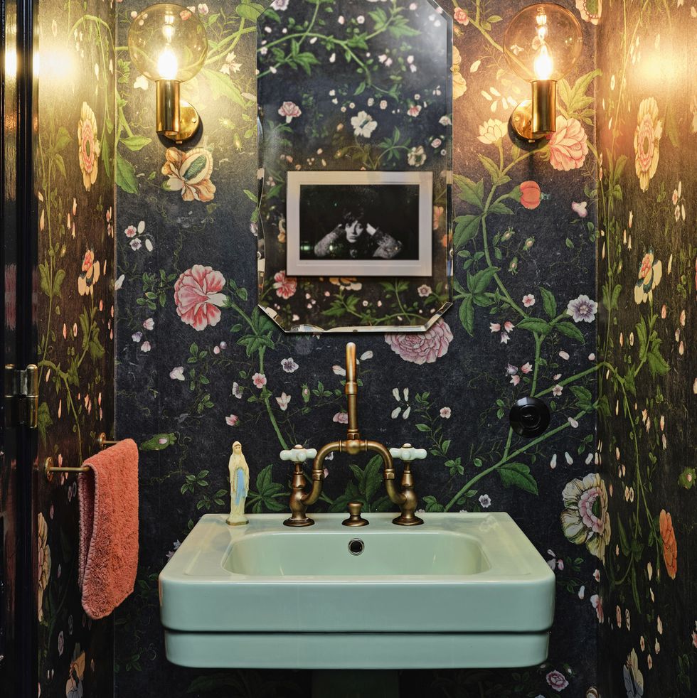 amsterdam home of actor carice van houten designed by nicole dohmen of atelier nd interior powder room the mint green art deco sink and hardware, sourced from affaire d’eau, freshen up a moody pierre frey wallpaper sconces and mirror vintage