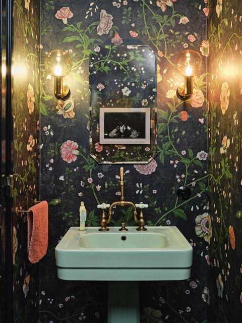 amsterdam home of actor carice van houten designed by nicole dohmen of atelier nd interior powder room the mint green art deco sink and hardware, sourced from affaire d’eau, freshen up a moody pierre frey wallpaper sconces and mirror vintage