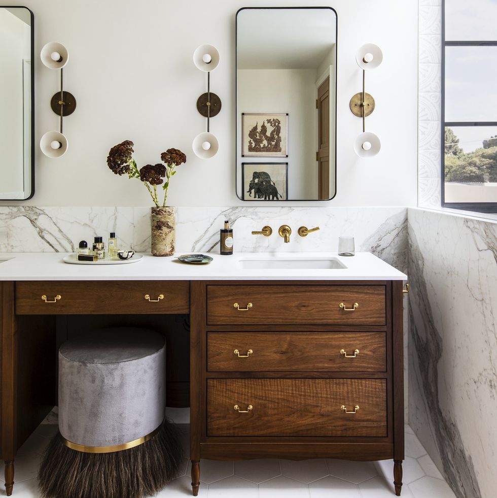 1920s spanish colonial in san francisco designed by regan baker design and landscape architect terremoto primary bath a custom vanity by midland cabinet company resembles an antique dresser counters and wainscot calacatta oro floor tile ann sacks sconces apparatus studio fixtures waterworks runner etsy stool coup d’etat