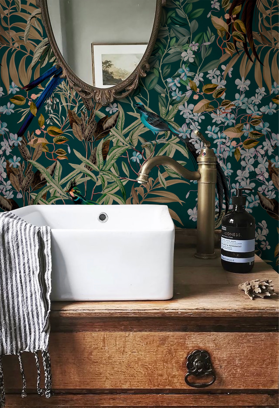 deus ex gardenia woodland wallpaper on bathroom wall with mirror, vanity unit and drawers