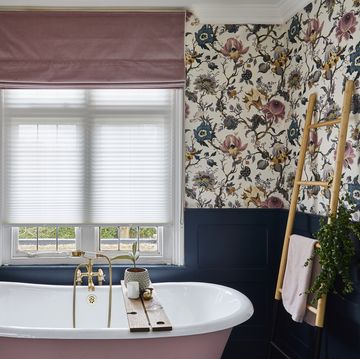 pink freestanding bathtub with blue wall panels, floral wallpaper and darcia velvet rose roman 2021 bathroom