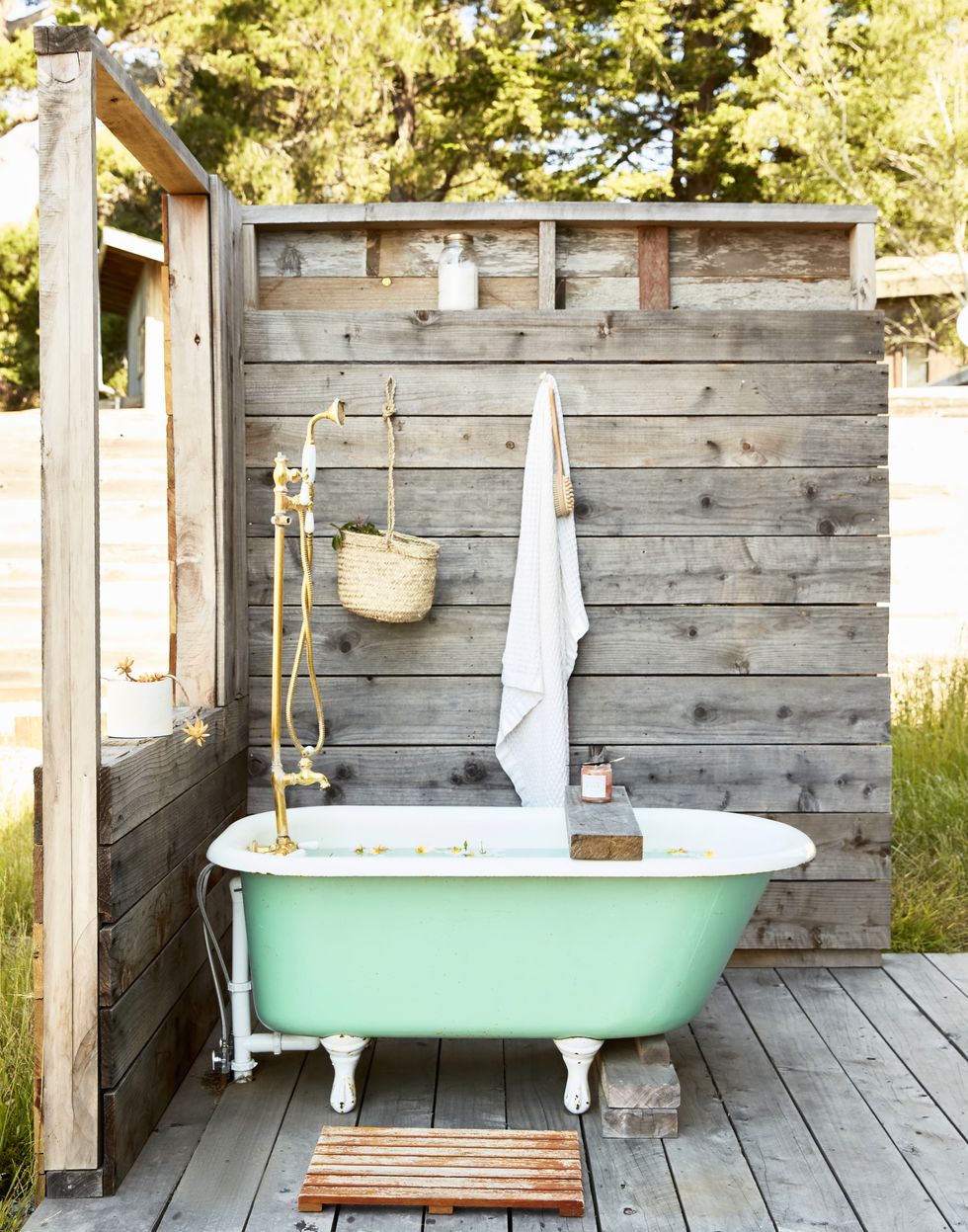 outdoor shower with with green claw foot tub, claw foot bathtub deck