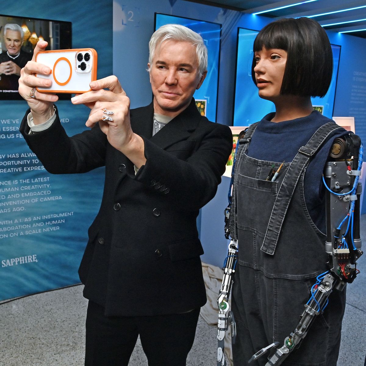 london, england april 19 baz luhrmann and ai da robot attend the launch of the bombay sapphire "saw this, made this" installation created in collaboration with baz luhrmann at the design museum london on april 19, 2023 in london, england the installation will be open to the public from 21st to 24th april 2023 pic credit dave benett
