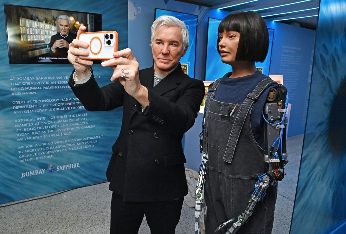 london, england april 19 baz luhrmann and ai da robot attend the launch of the bombay sapphire "saw this, made this" installation created in collaboration with baz luhrmann at the design museum london on april 19, 2023 in london, england the installation will be open to the public from 21st to 24th april 2023 pic credit dave benett