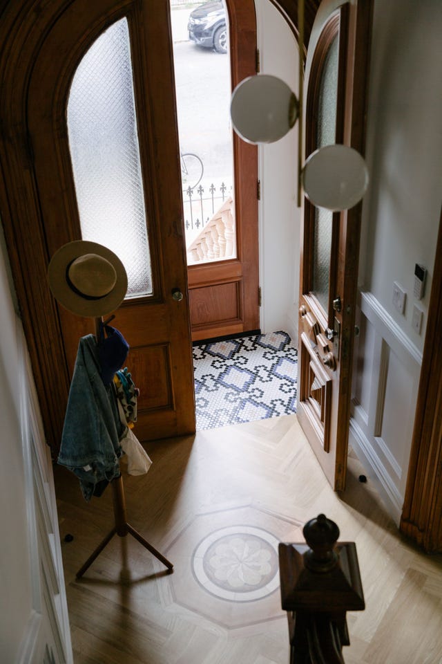a room with a mirror and a chair
