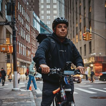 a man poses for a portrait on an ebike in new york city