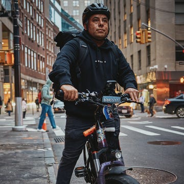 a man poses for a portrait on an ebike in new york city