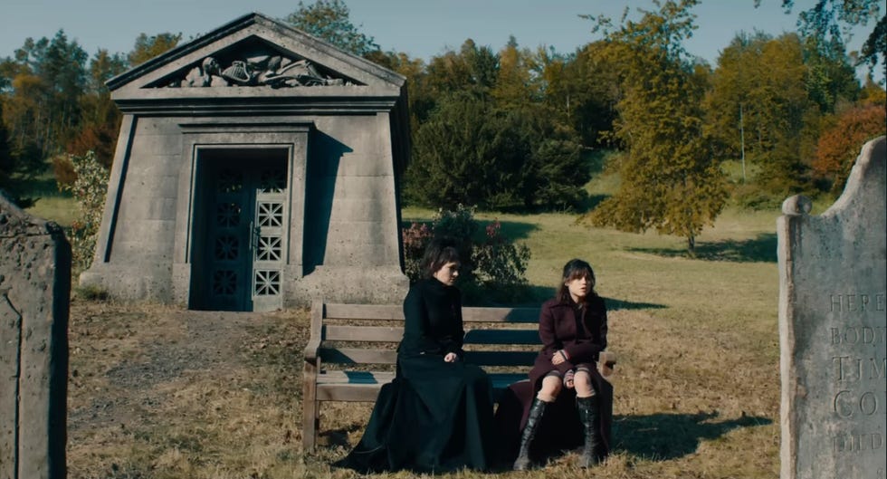 astrid and lydia have a serious talk near a grave with the name tim on it