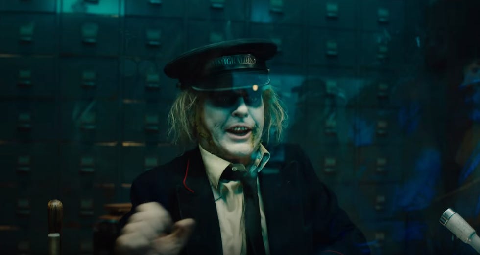 betelgeuse wears a hat that says immigration in a scene from beetlejuice beetlejuice