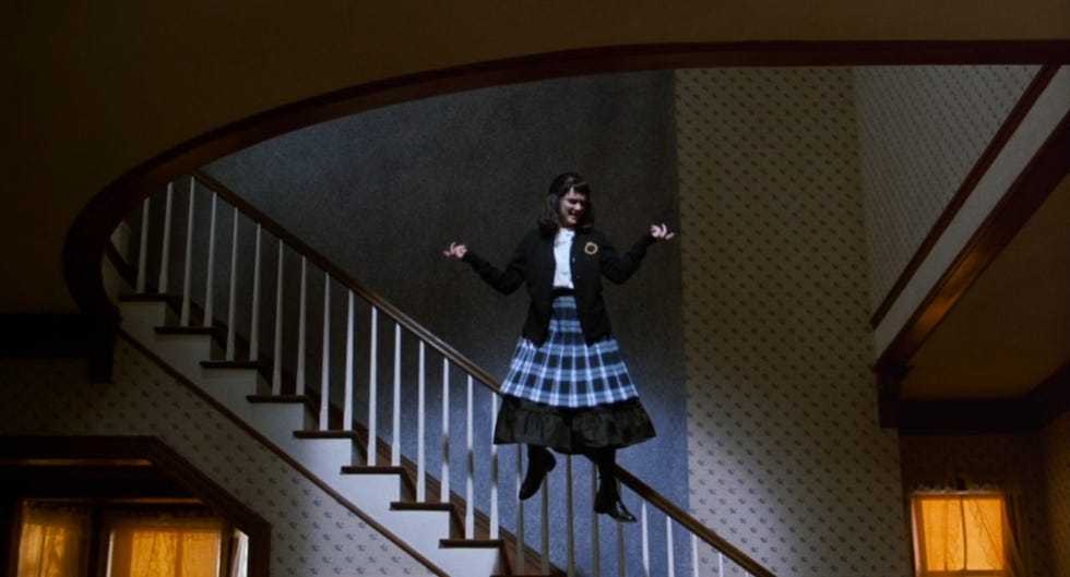 lydia deetz dances to jump in the line while wearing her school uniform in a scene from beetlejuice