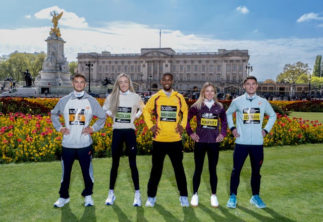 athletes posing in front of a historic building showcasing athletic wear