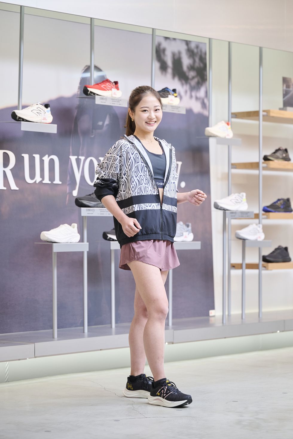a person posing in front of a display of shoes