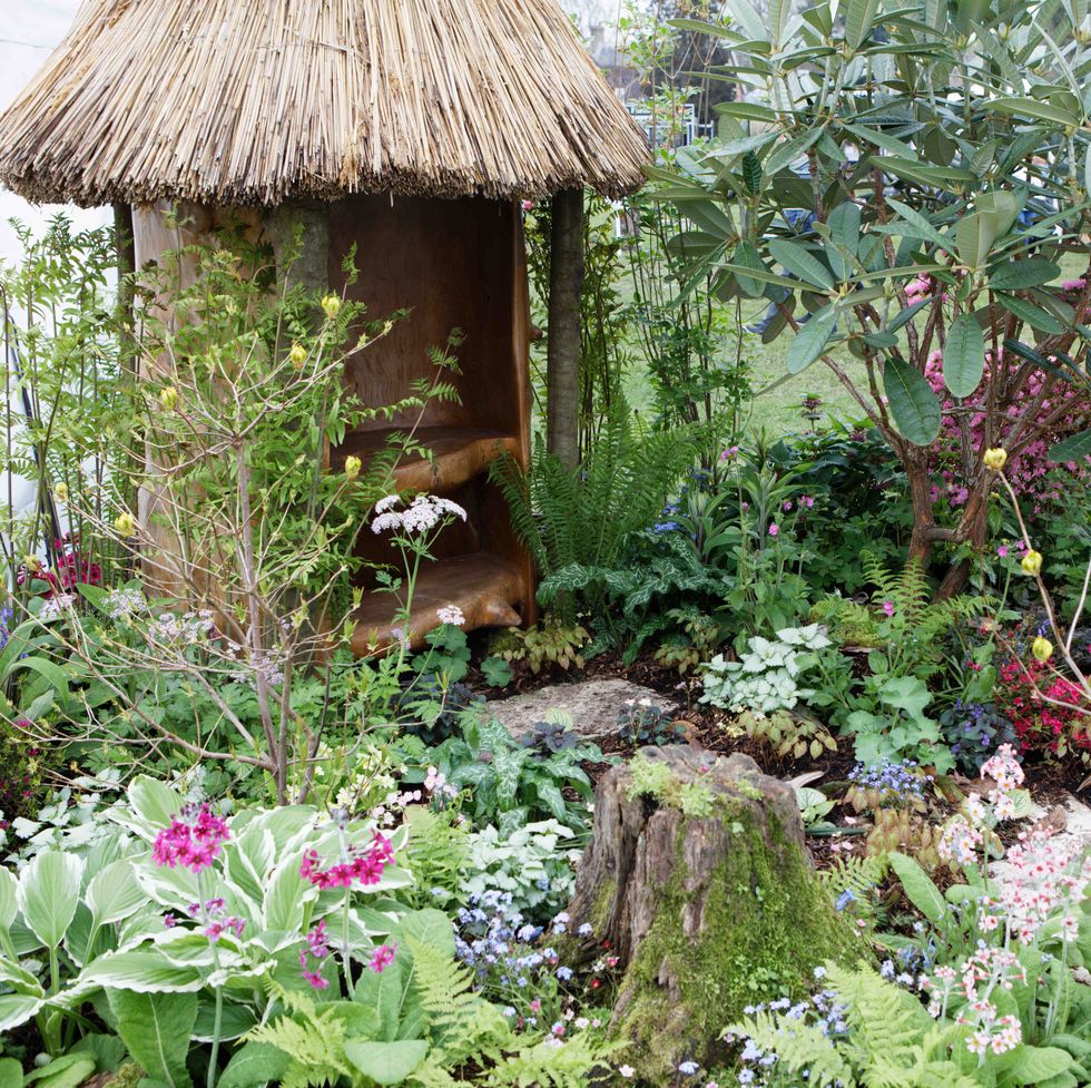 a small garden with a small hut